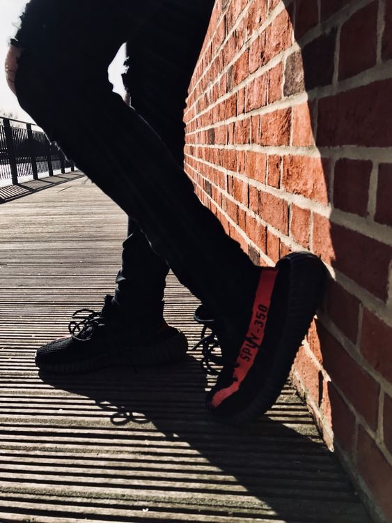 yeezy red stripe on feet
