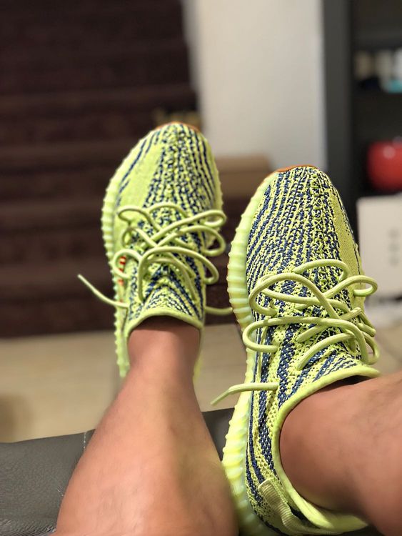 frozen yellow yeezys on feet