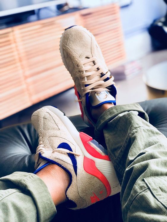 white nike air force 1 with blue swoosh